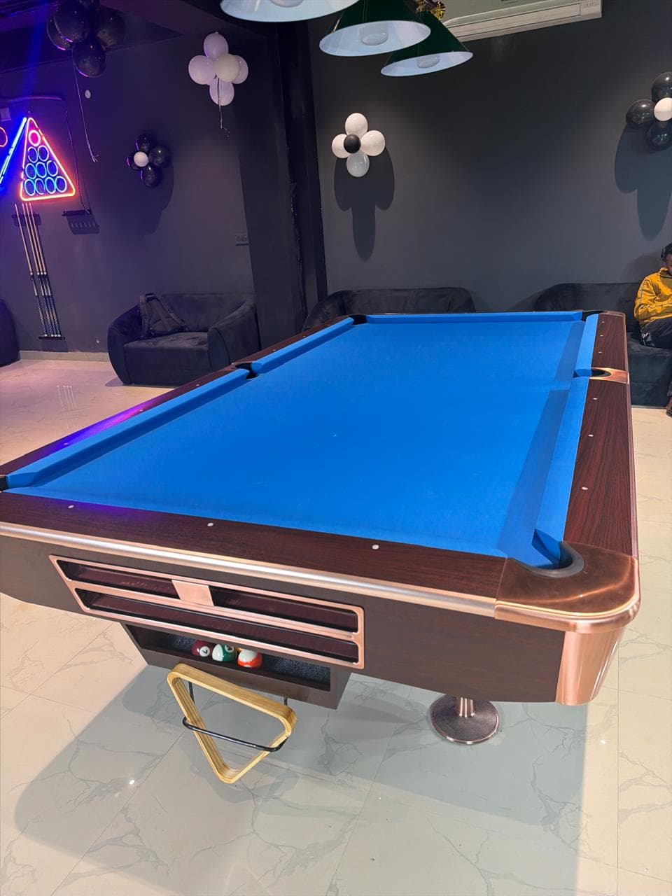 Pool table and neon billiards sign inside Flames 147